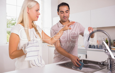 Couple washing dishes together