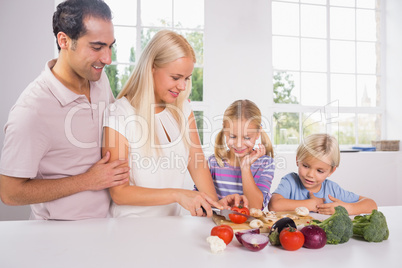Family cutting vegetables together