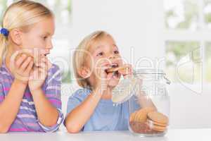 Brother and sister eating biscuits