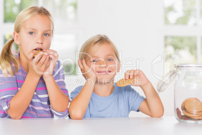 Brother and sister eating biscuits together