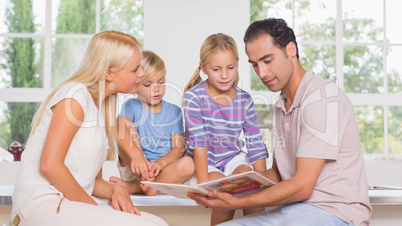 Calm family reading a story together