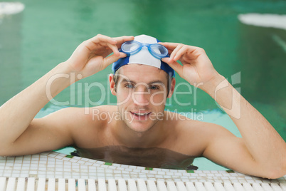 Man taking off his swimming goggles
