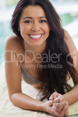 Happy girl lying by the pool