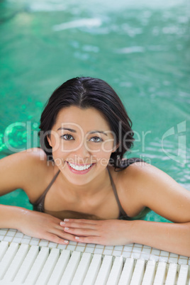 Woman looking up from swimming pool