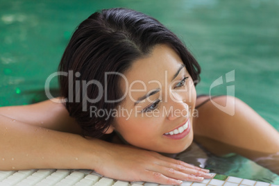 Attractive brunette relaxing in pool