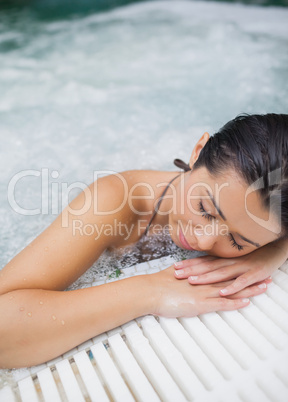 Woman resting at edge of jacuzzi