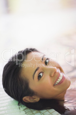 Pretty smiling woman lying in a jacuzzi