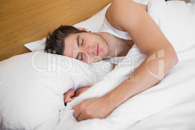 Handsome male sleeping in bed