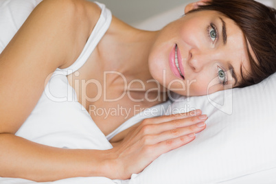 Beautiful woman smiling in bed