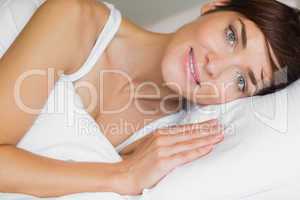 Beautiful woman smiling in bed