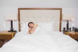 Brunette woman sleeping in bed