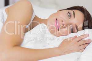Female smiling in bed