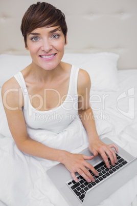 Woman looking up from laptop