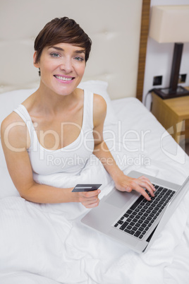 Smiling woman looking up from shopping online