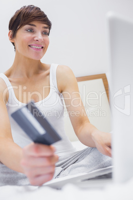Woman shopping online in hotel room