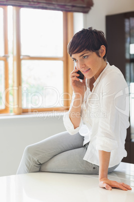 Woman calling sitting on the couter