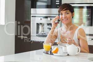 Woman talking on the phone at breakfast