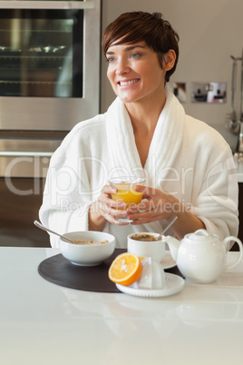 Smiling woman having breakfast