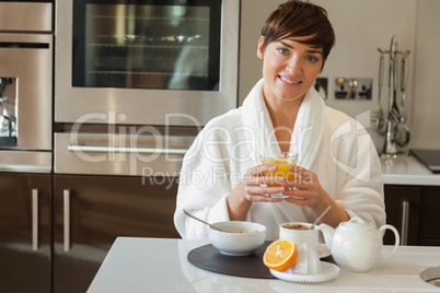 Woman drinking orange juice with breakfast