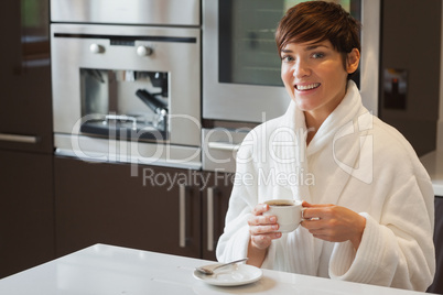 Girl drinking a coffee in the kitchen