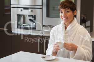 Girl drinking a coffee in the kitchen