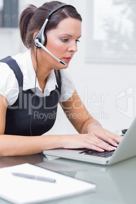 Business woman wearing headset in office