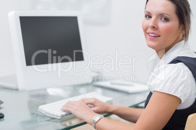 Confident female executive using computer at office