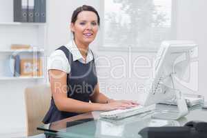 Portrait of confident female executive using computer