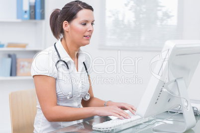 Female doctor using computer at clinic