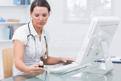 Doctor using computer to prepare an online prescription