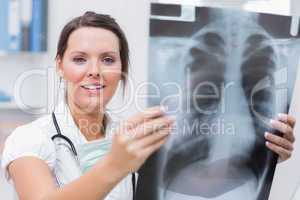 Female doctor holding x-ray at clinic