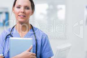 Female surgeon holding digital tablet at clinic