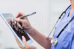 Female doctor using digital tablet