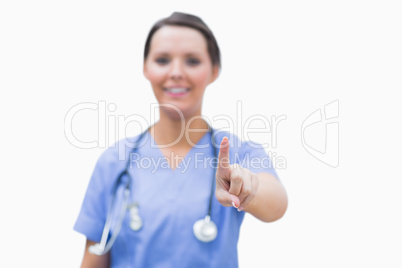 Portrait of surgeon pointing at invisible screen