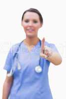 Portrait of female surgeon pointing at invisible screen