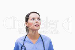 Female surgeon looking up thoughtfully