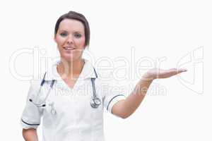 Portrait of female nurse holding out open palm