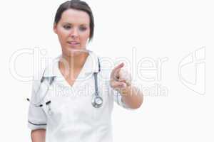 Female nurse pointing at invisible screen