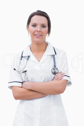 Portrait of smiling nurse standing with arms crossed