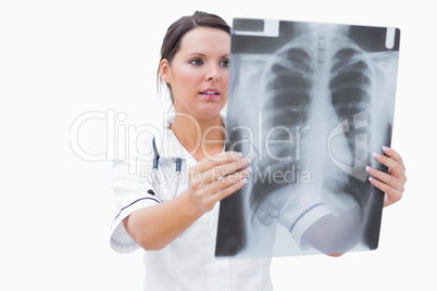 Young female nurse examining x-ray