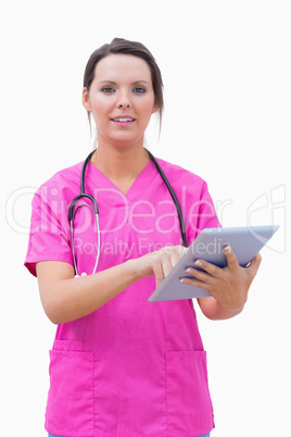 Portrait of young nurse using digital tablet