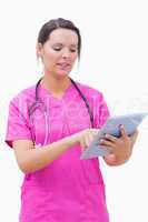 Young nurse using digital tablet