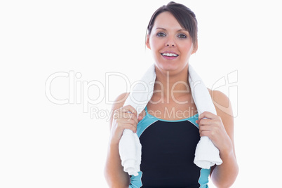 Portrait of woman in sportswear holding towel around neck