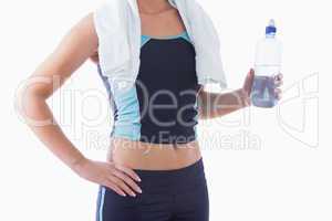 Sporty woman with towel around neck and water bottle