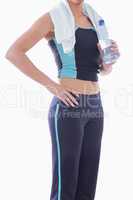 Sporty woman with towel around neck and water bottle