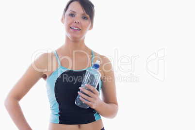 Portrait of young woman in sportswear holding water bottle