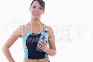 Portrait of young woman in sportswear holding water bottle