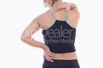 Rear view of sporty young woman massaging neck