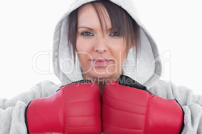 Close-up of young woman wearing boxing gloves