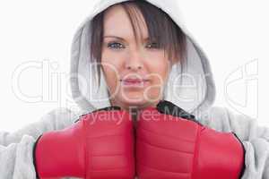 Close-up of young woman wearing boxing gloves